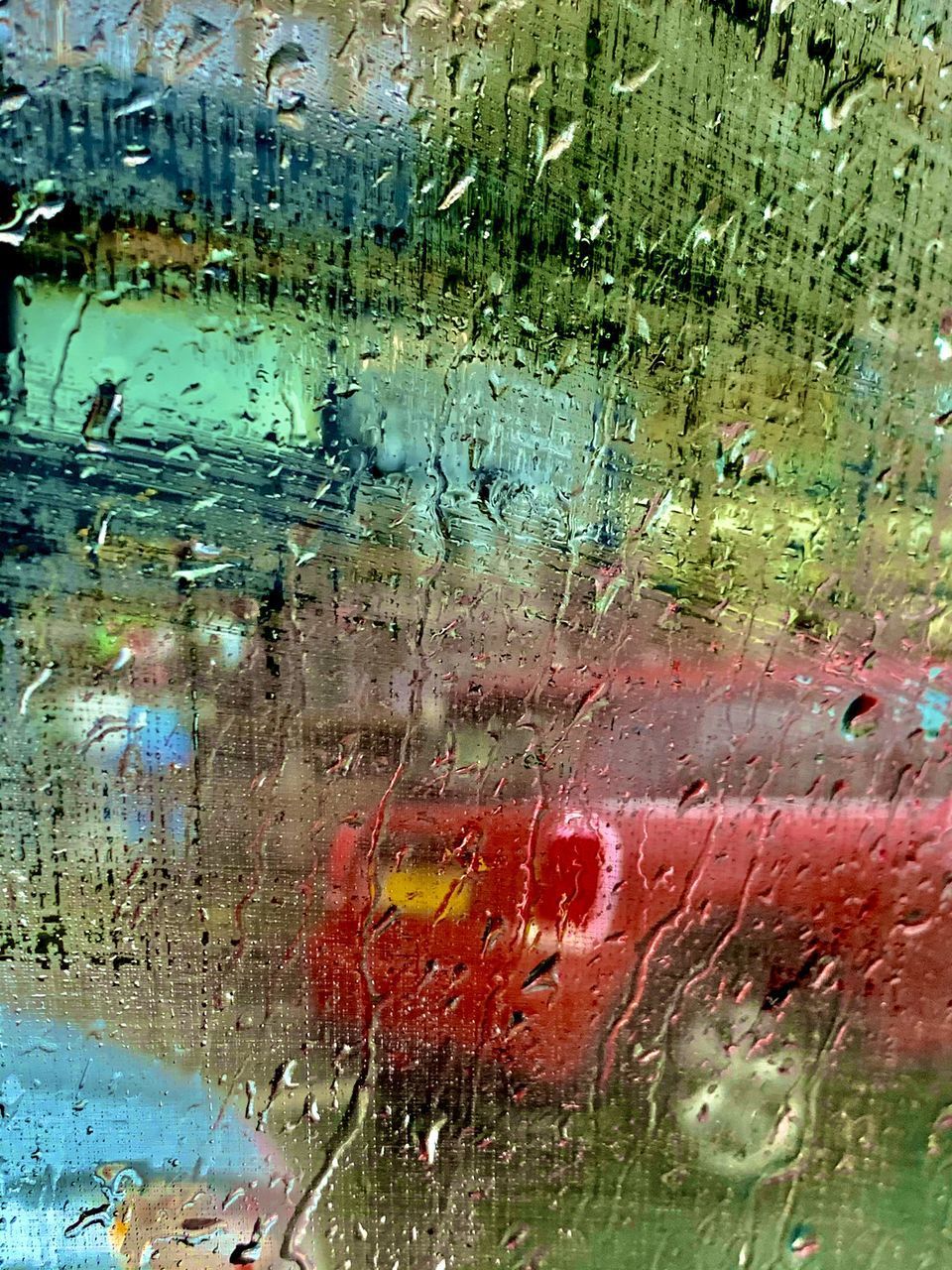 FULL FRAME SHOT OF RAINDROPS ON GLASS WINDOW