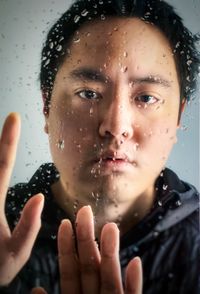 Close-up portrait of woman with wet hand