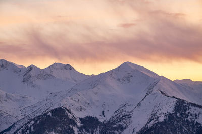 Scenic view of snowcapped mountains against sky during sunset