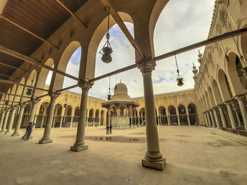 View of colonnade and buildings against sky