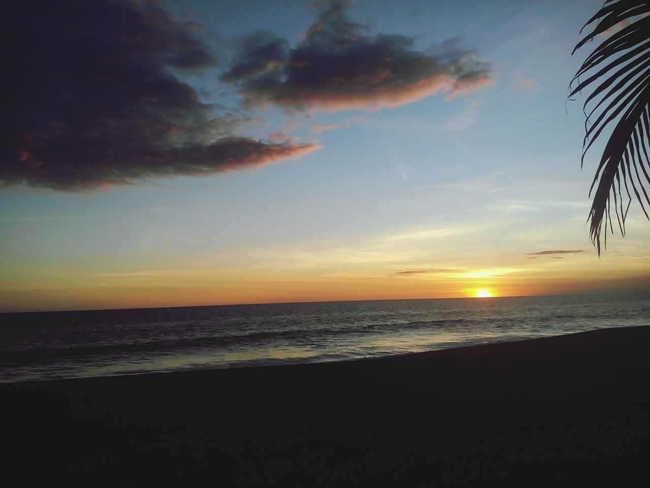 sea, horizon over water, sunset, beach, water, scenics, sky, tranquil scene, beauty in nature, tranquility, shore, sun, idyllic, orange color, nature, cloud - sky, cloud, outdoors, remote, no people, coastline, non-urban scene, sunbeam, majestic, cloudy