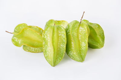 Close-up of green chili pepper against white background