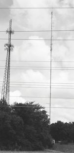 Low angle view of electricity pylon against sky