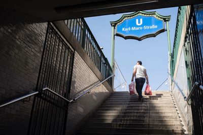 Rear view of man walking on steps