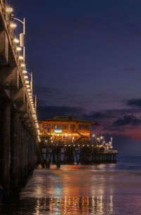 Evening falls and the pier lights up