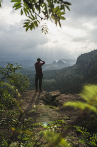 Rear view of man photographing nature