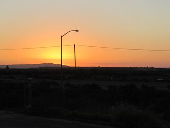 Silhouette landscape against sky during sunset