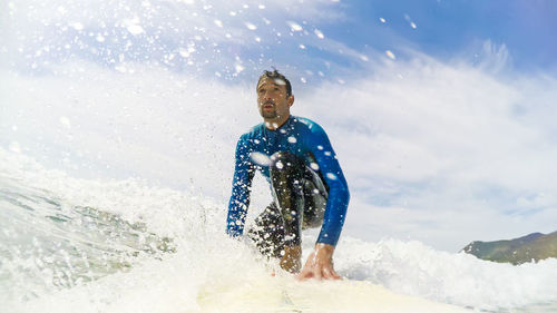 Full length of man standing in sea against sky