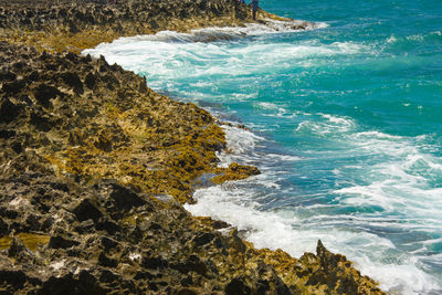 High angle view of rocks at sea shore