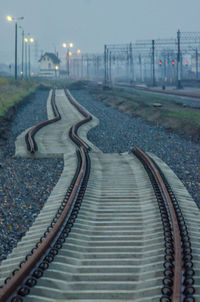 High angle view of railroad tracks by street against sky