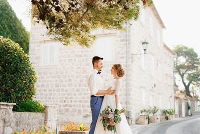 Young couple embracing while standing on street