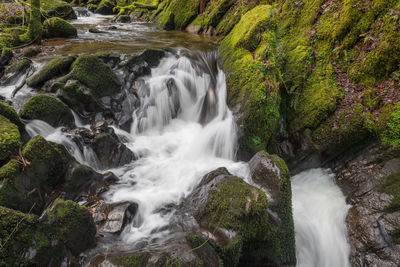 Long exposure of a waterfall flowing over rocks at watersmeet in exmoor national park