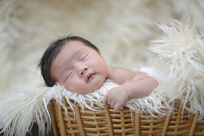 Cute baby sleeping in basket