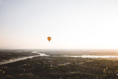 Hot air balloon flying over city