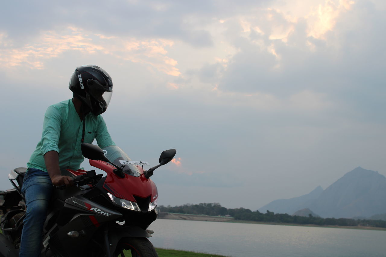 FULL LENGTH OF MAN RIDING HORSE ON MOUNTAIN AGAINST SKY