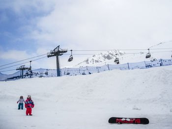 Overhead cable car against sky during winter