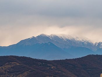 Scenic view of snowcapped mountains against sky