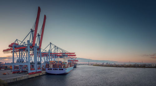 Commercial dock by sea against sky