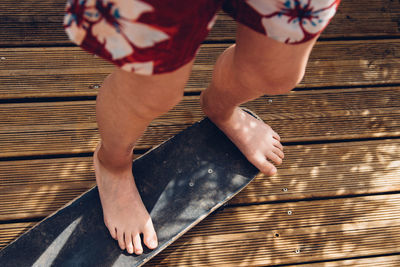 Low section of man standing on skateboard