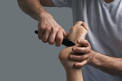 Midsection of man holding hands