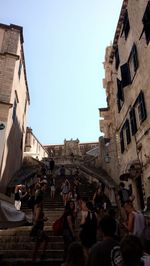 People on road against buildings