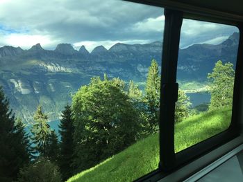 Scenic view of mountains against cloudy sky