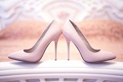 Close-up of high heels stilettos on bed at home