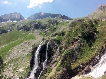 Scenic view of waterfall against sky