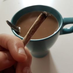 Close-up of hand holding coffee cup