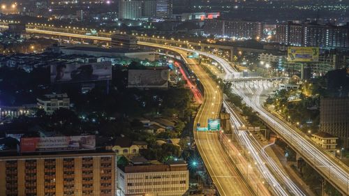 High angle view of light trails on road in city at night