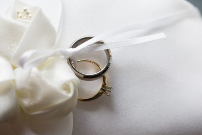 High angle view of wedding rings on white table
