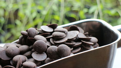 High angle view of chocolate chips in measuring spoon on table