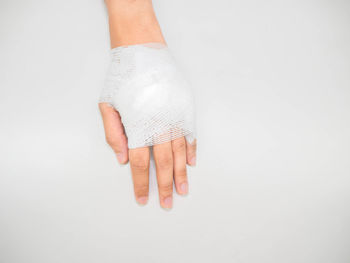 Close-up of human hand against white background