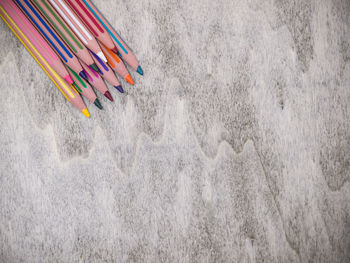 High angle view of colored pencils on wooden table