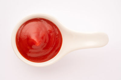 High angle view of red juice against white background
