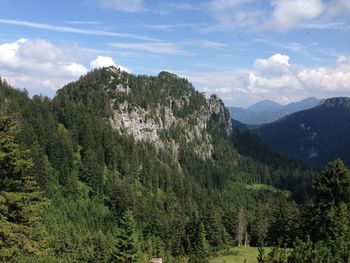 Scenic view of mountains against cloudy sky