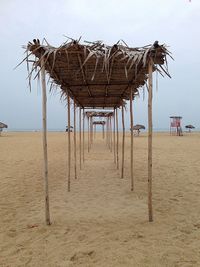 Parasols on beach against clear sky