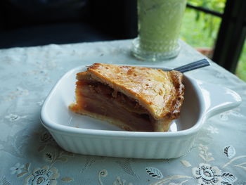 Close-up of apple pie and ice green tea on the table