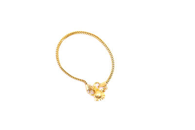 Close-up of gold colored pencils against white background