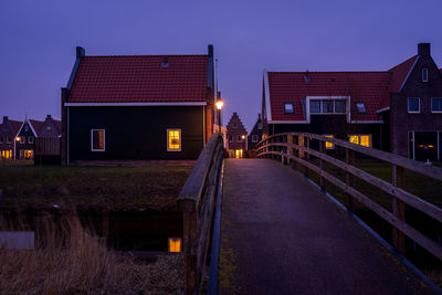 Illuminated buildings against sky at night