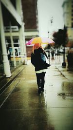 Woman walking on road in city