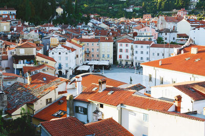Red roofs of old town piran with main church against the sunrise sky, adriatic sea. slovenia