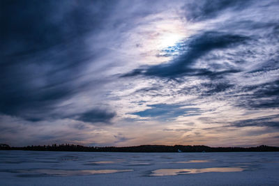 Scenic view of beach against sky during sunset