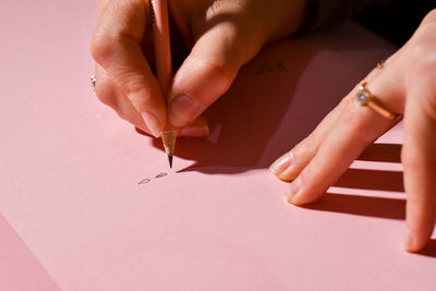 Cropped hand of woman drawing on paper