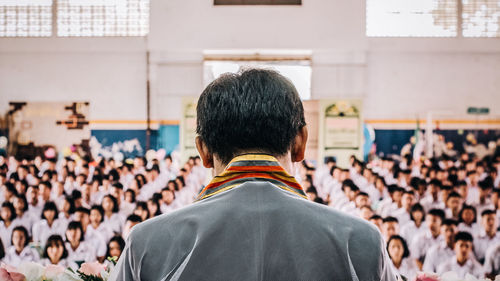 Rear view of people standing outdoors