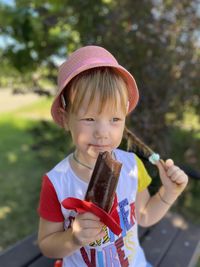 Cute girl eating ice cream outdoors