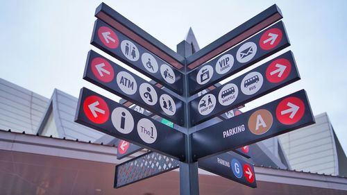 Low angle view of road sign against building