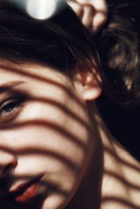 Close-up of young woman reflecting on mirror