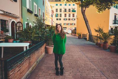 Full length portrait of woman on footpath