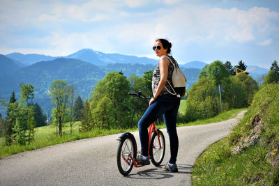 Young woman riding bicycle on road